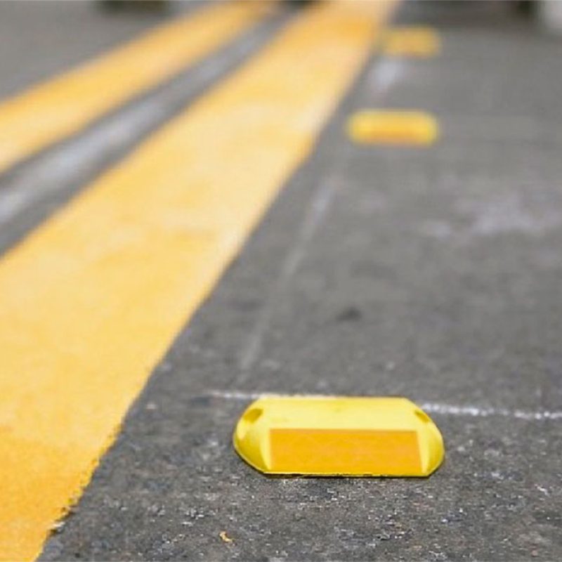 ¿Tu Proyecto en Lima Espera? Descubre la Disponibilidad Inmediata y Beneficios de las Mejores Tachas Viales 2 Tachas viales de color amarillo instaladas en el asfalto de una concurrida avenida de Lima